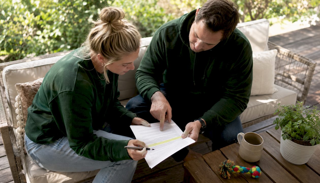 Couple reviewing puppy health guarantee contract